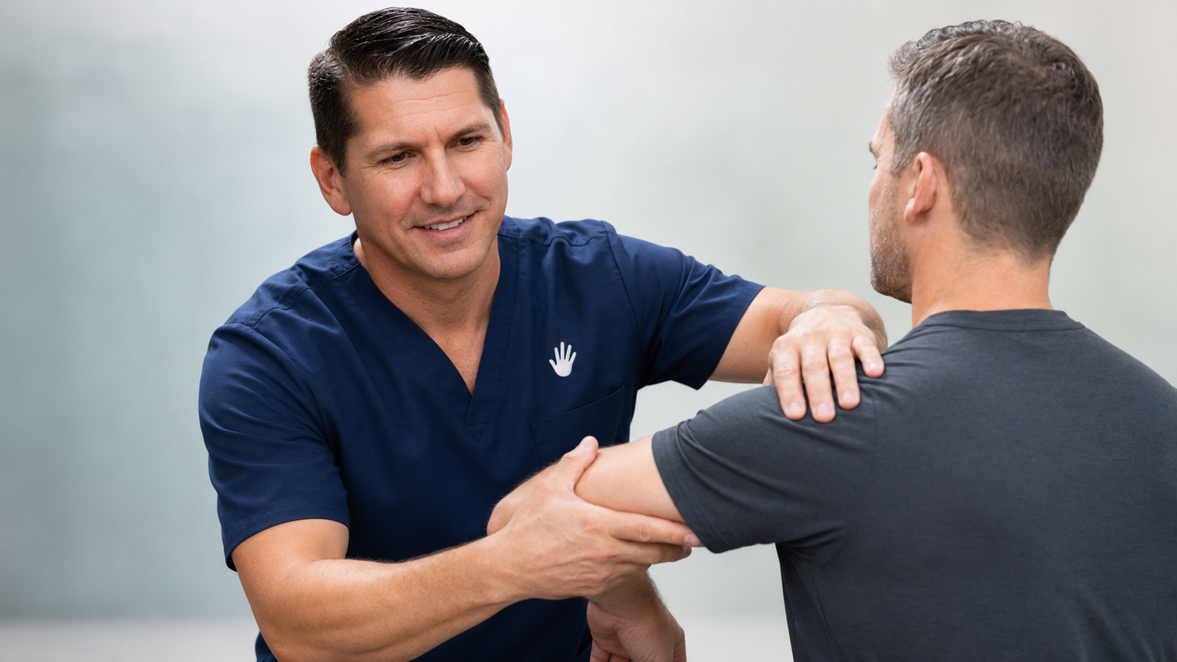 Physiotherapist assessing a patient's shoulder
